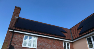 solar panels on roof of a house with blue sky in the background